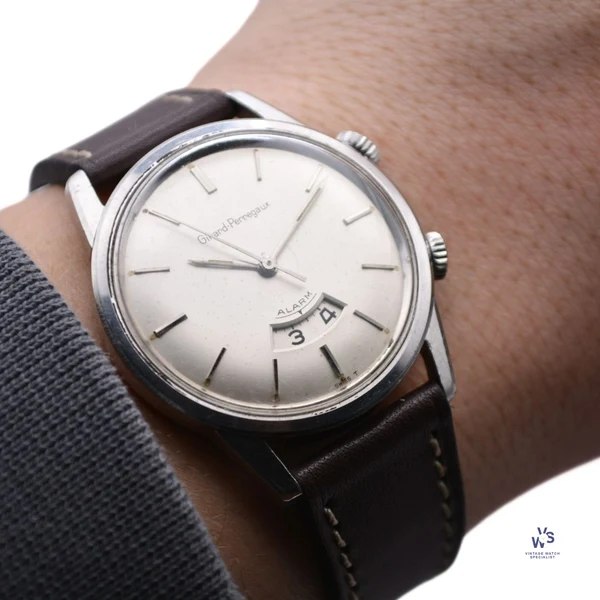 Oblique view of the Girard-Perregaux alarm wristwatch on the wrist showing dial and dual crowns