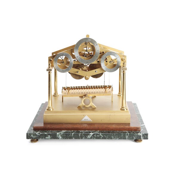 Front view of the Congreve rolling ball clock showing the three chapter rings, tilting track, brass columns, and marble base