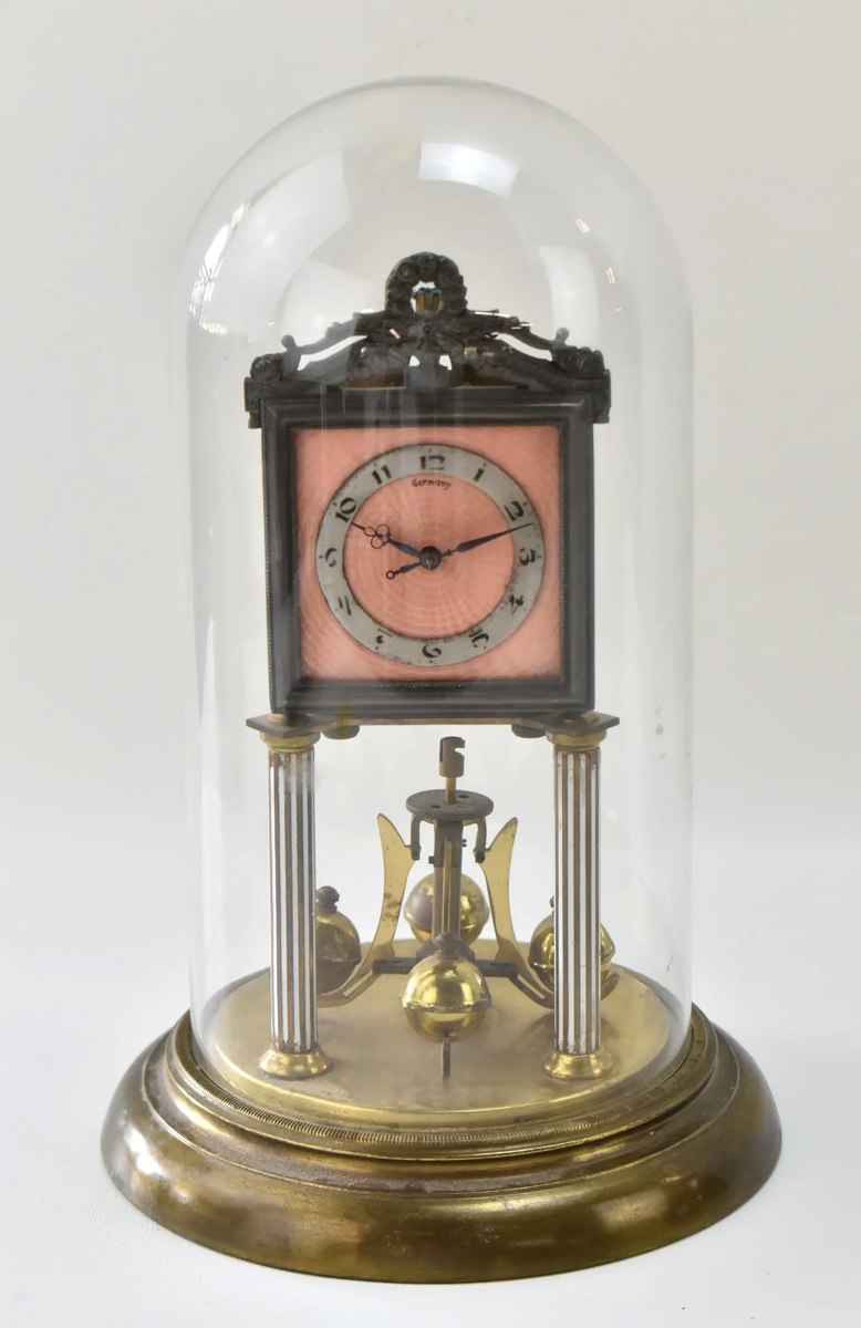 Front view of Jahresuhren-Fabrik 400-day torsion clock under glass dome with pink enamel dial