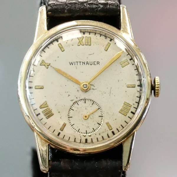 Front view of the Wittnauer wristwatch showing the dial, subseconds track at 6 o'clock, and leather strap