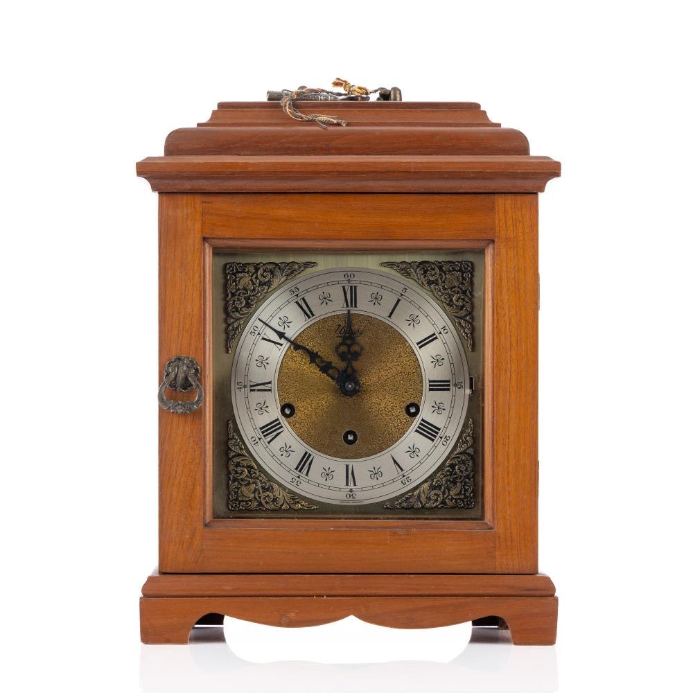 Front view of the cedar bracket clock showing dial, hands, and case details