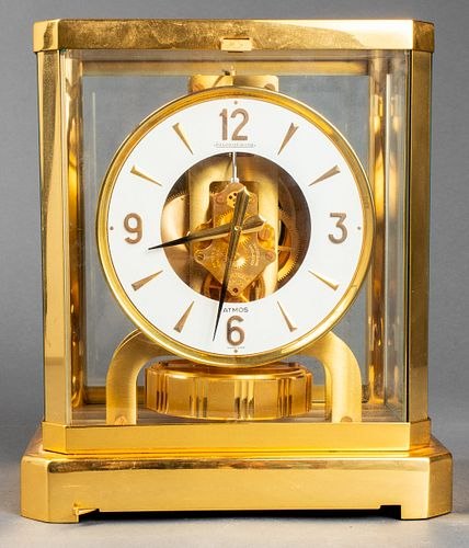 Front view of Le Coultre Atmos brass and glass clock showing dial and torsion pendulum