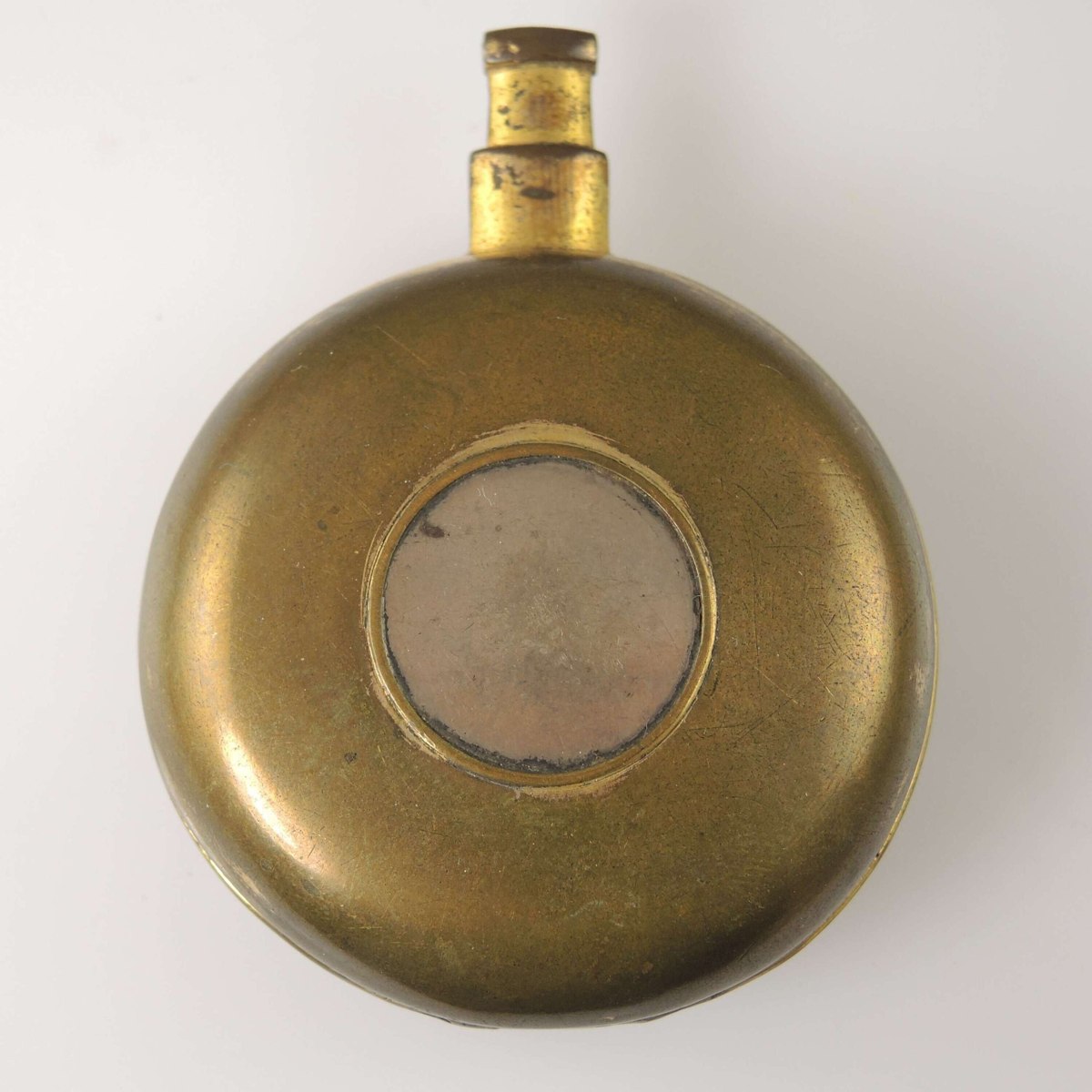 Front view of the closed Georgian gilt pocket watch case showing the filled center aperture