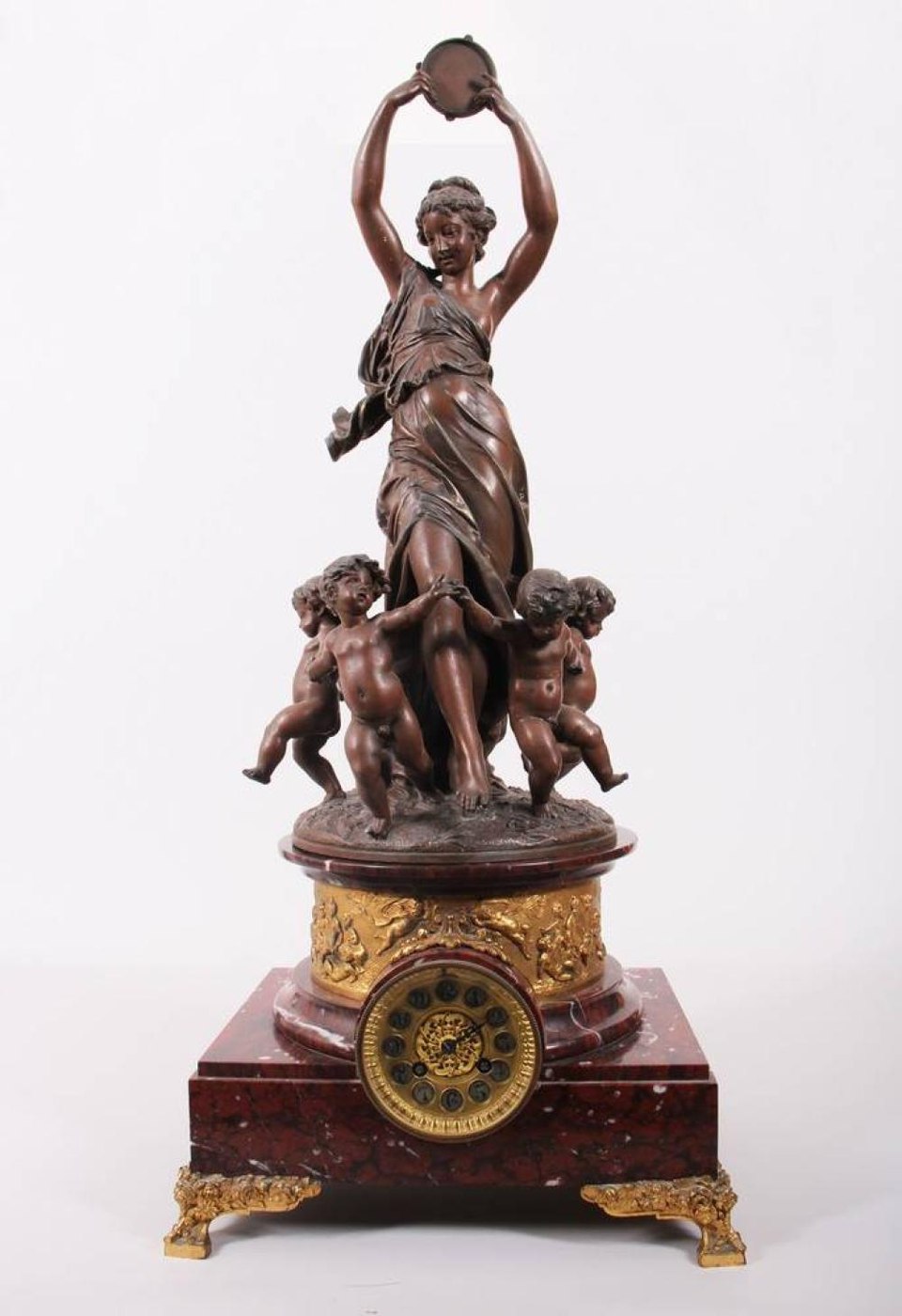 Full view of the figural pendulum clock showing the 'Song of Venus' bronze sculpture atop the marble and brass housing.