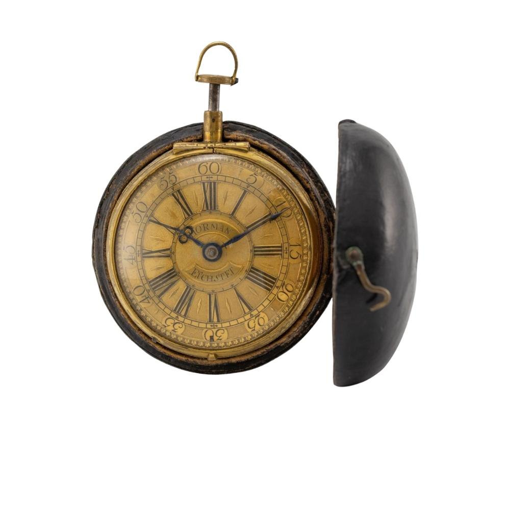 Front view of the Georg Hörman coach clock with gilt champlevé dial in an opened outer leather case