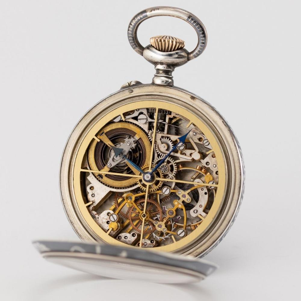 Full view of the open-faced pocket watch, showing the skeletonised dial and internal bridge movement.