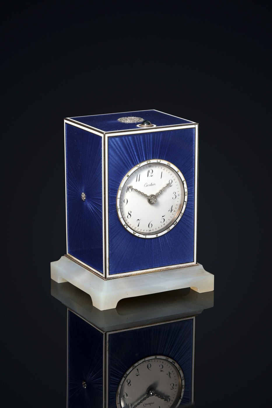 Cartier carriage clock in its original leather case, featuring a blue enamel finish and diamond accents.