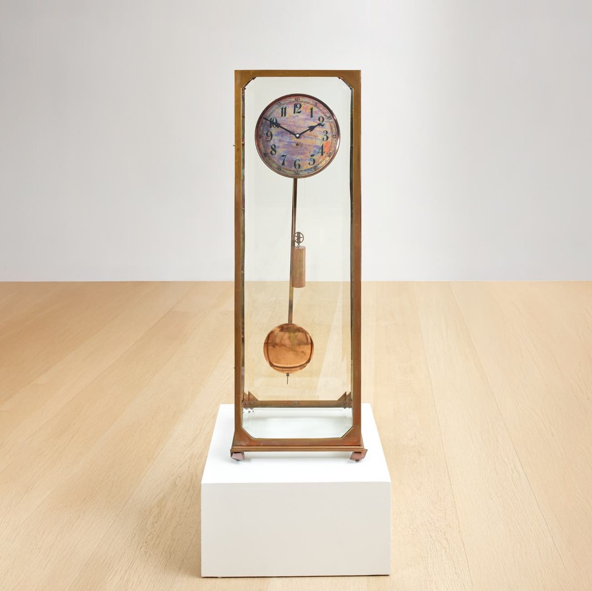 Full front view of the Adolf Loos glazed brass longcase clock