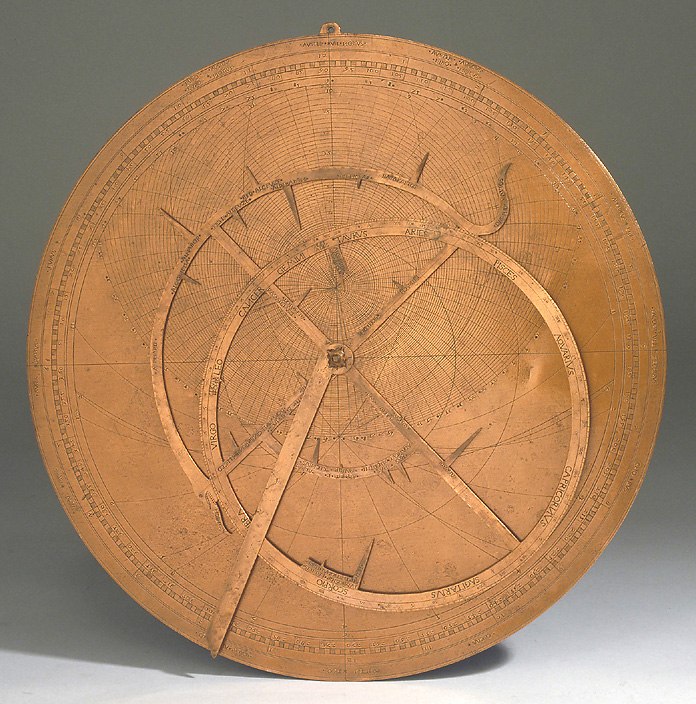 Frontal view of the copper astrolabe showing the rete, ecliptic circle, and plate engravings.