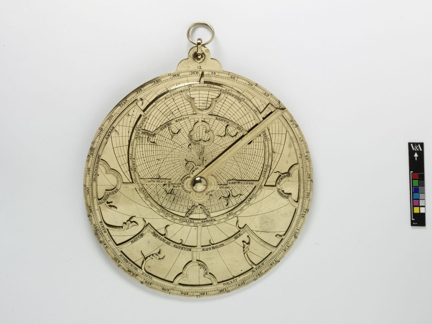 Front view of the 14th-century brass astrolabe showing the rete, star pointers, and central alidade.