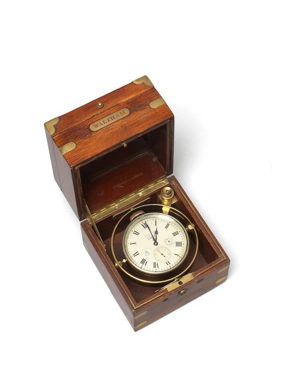 Elevated view of the open mahogany box showing the Waltham marine deck watch mounted on its brass gimbal