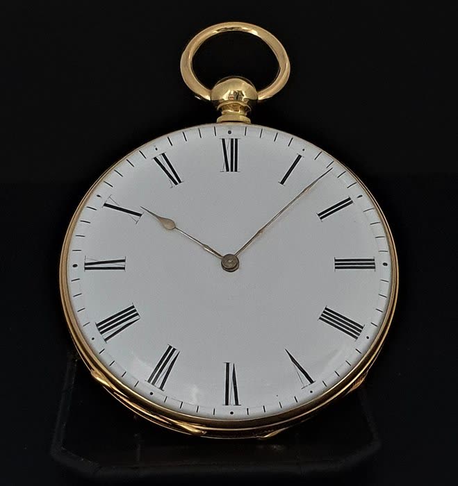 Front view of an unsigned open-face pocket watch with white dial and top bow