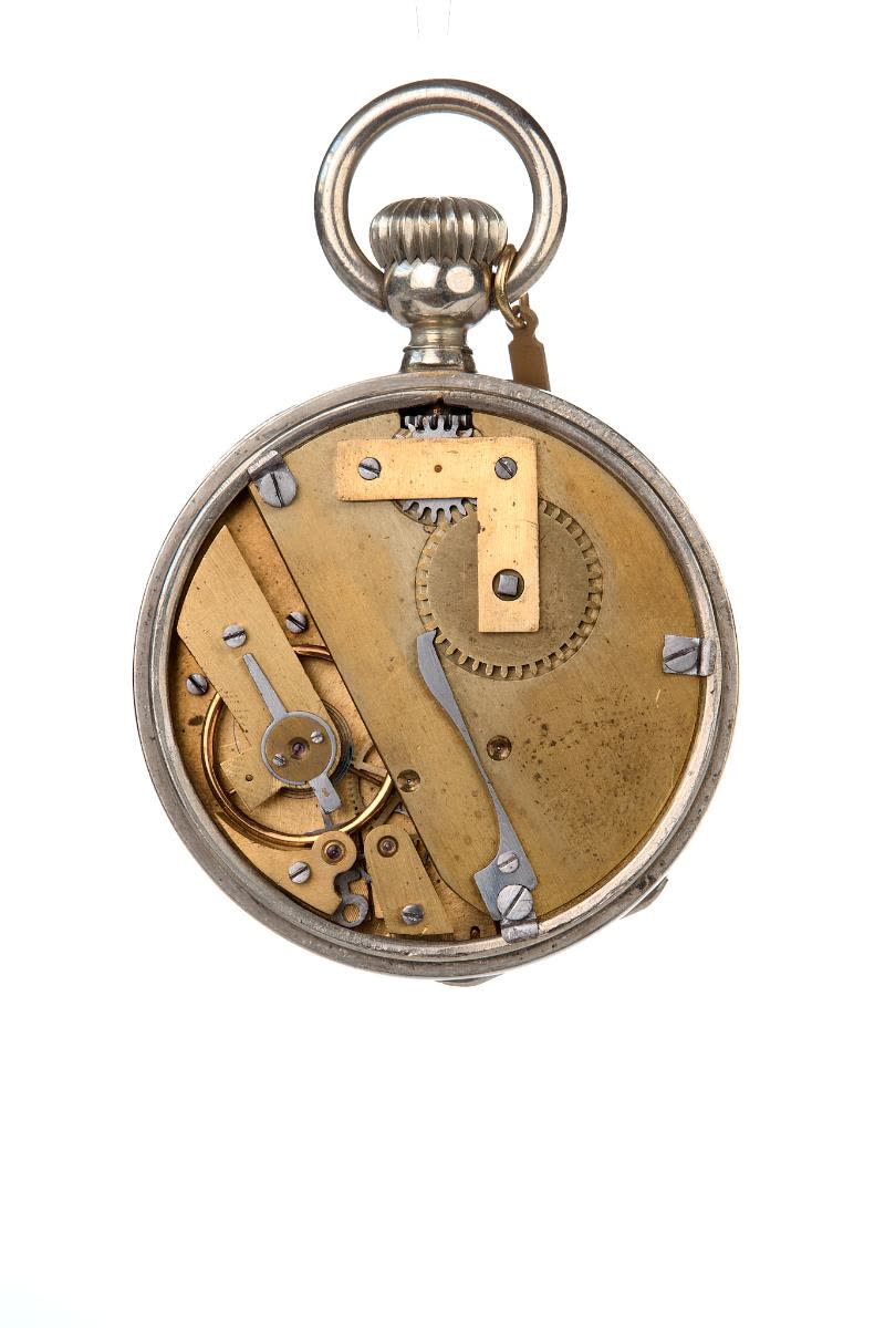 The bezel of the very heavy nickel silver case may be opened to set the hands manually (MIH I-375)