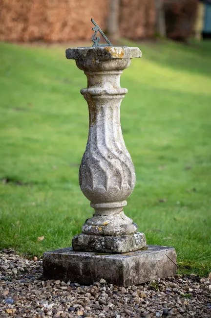 Full-length view of the Portland stone baluster pedestal sundial on a square plinth