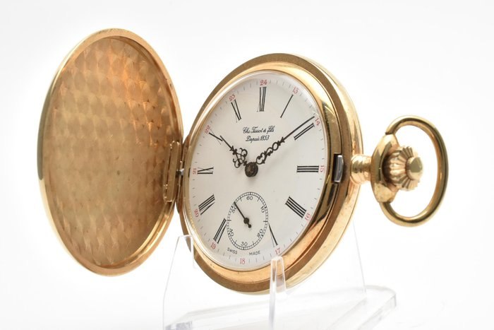 Front three-quarter view of the open Tissot hunter-case pocket watch showing dial and inside cover