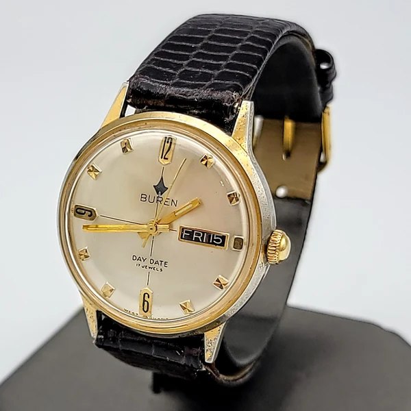 Three-quarter view of the Buren Day/Date 17 Jewels wristwatch on a black strap