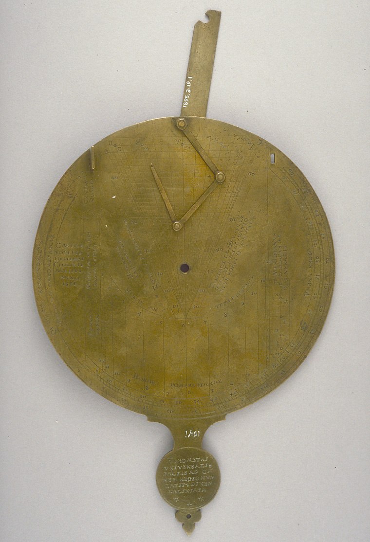 The nocturnal side of the gilt brass instrument featuring the lunar volvelle and maker signature.