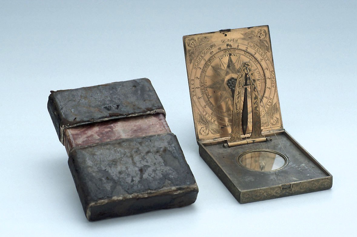 Horizontal sundial with leather-covered pasteboard case, open to reveal the horizontal string-gnomon dial and internal wind rose.