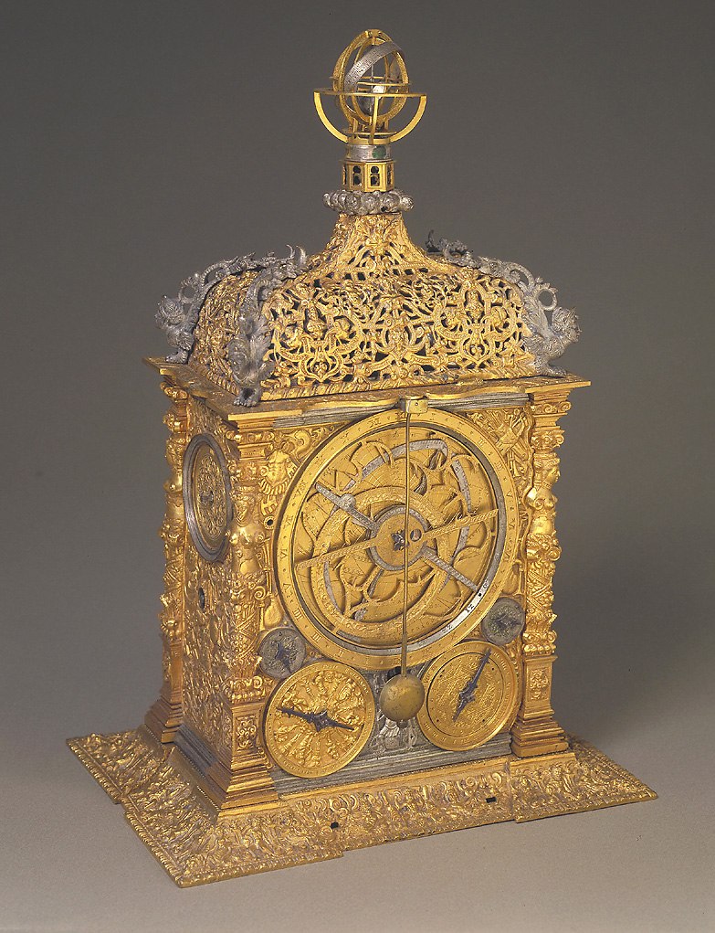 The gilt brass astronomical clock showing the astrolabe dial and the upper armillary sphere.