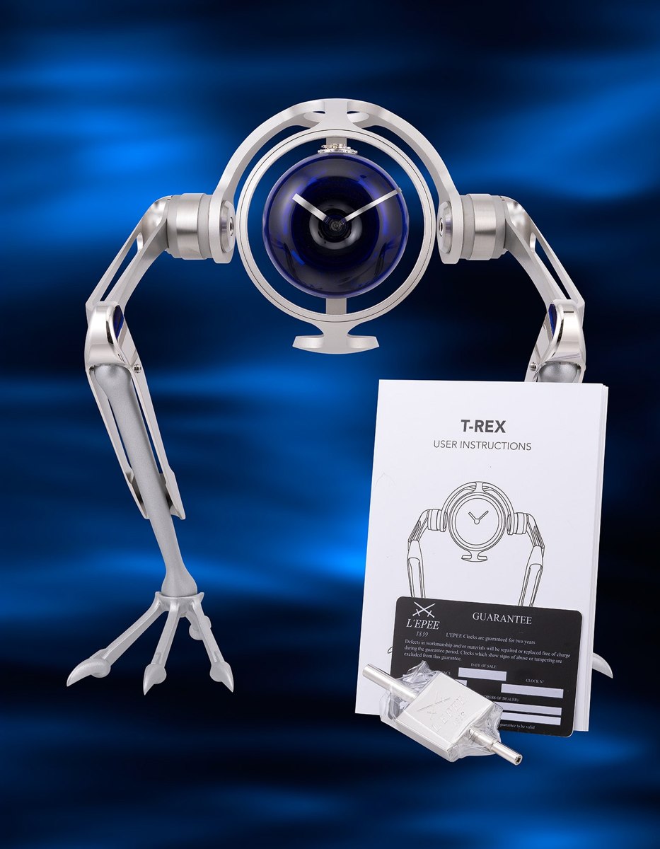 MB&F and L'Epée reference 76.6008/140 T-Rex table clock shown with user instructions, guarantee card, and winding key