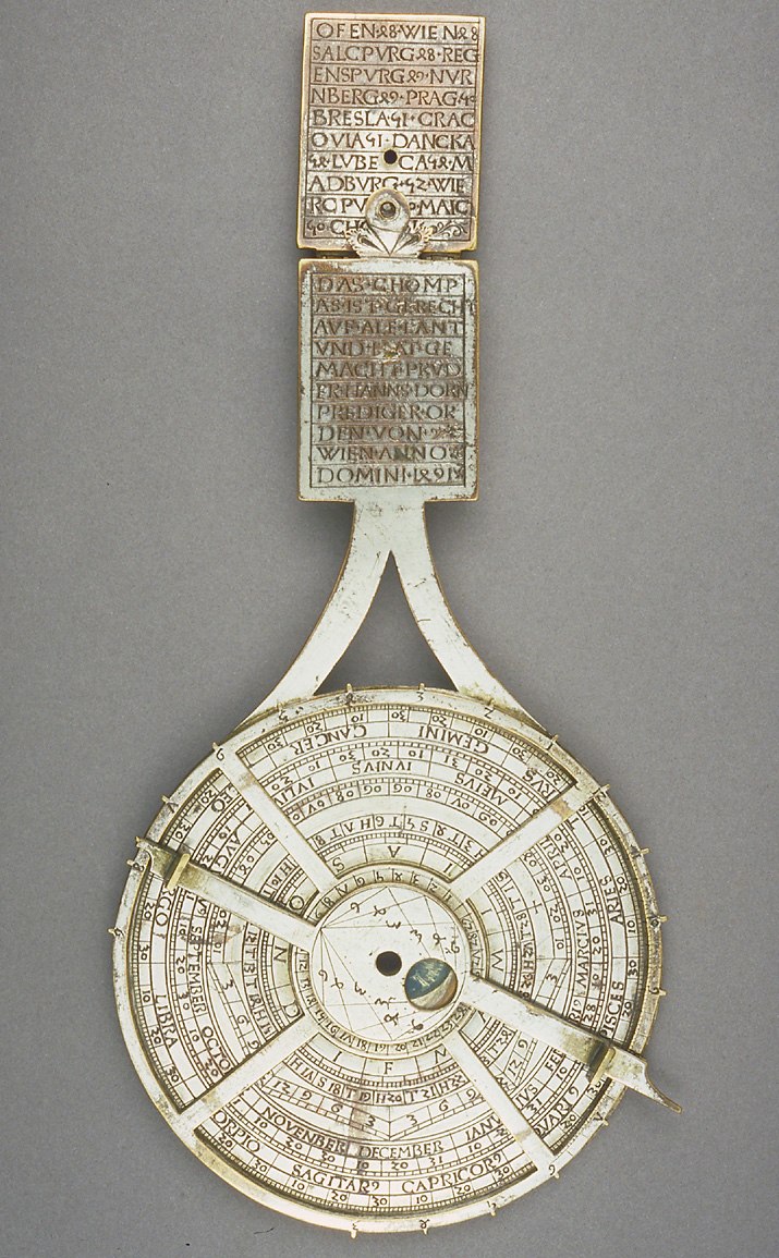 Front view of the nocturnal showing the ecliptic circle, ruler, and city list on the handle extension.