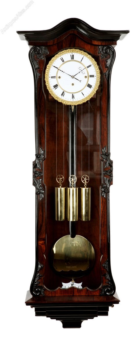 Front view of the rosewood Grand Sonnerie Vienna regulator showing the case, dial, three weights, and pendulum