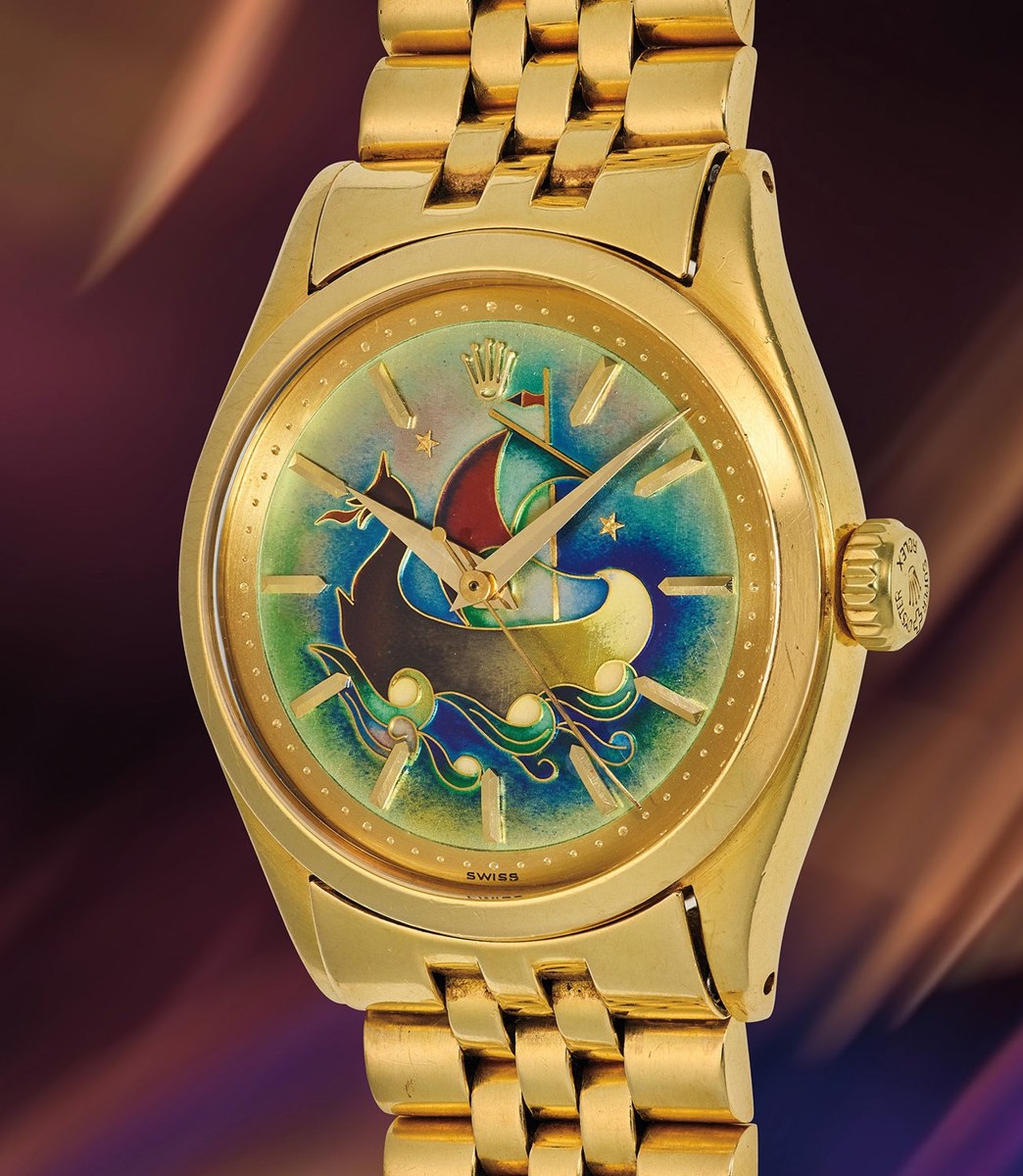 Front three-quarter view of the Rolex ref. 6100 showing the cloisonné enamel 'La Caravelle' dial, yellow gold case, and Jubilee bracelet.