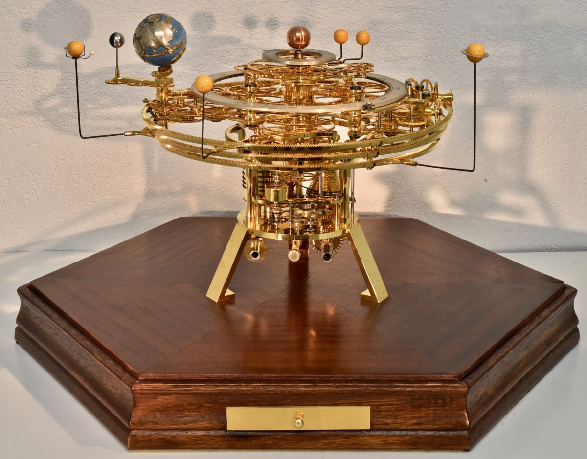 Full view of the Eric Watson clockwork orrery on its hexagonal wooden plinth