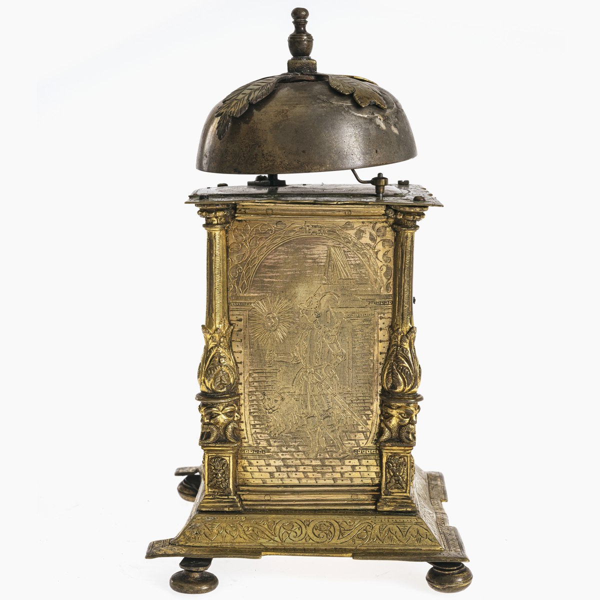 Side panel view of the tabernacle clock showing engraved figurative decoration, corner columns, and upper bell