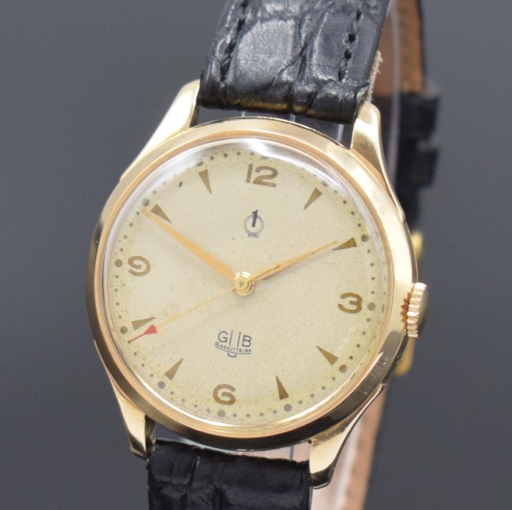 A front-facing view of the 14k gold GUB Güteuhr wristwatch, featuring the GUB Q1 signed silvered dial and alpha hands.