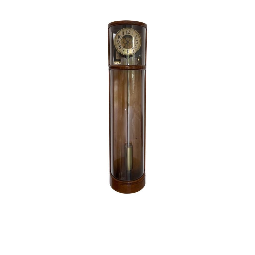 Full view of the motor-rewound pendulum clock showing the mahogany case, curved glass, and the internal brass movement.