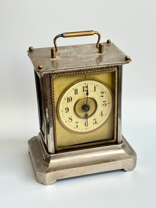 Three-quarter front view of the Junghans musical carriage clock showing dial, case, and handle