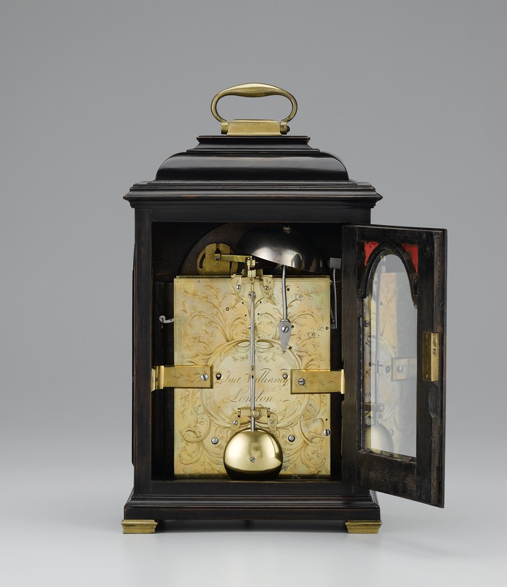 Rear view of the George III table clock by Justin Vulliamy, showing the engraved backplate, bell, and pendulum.