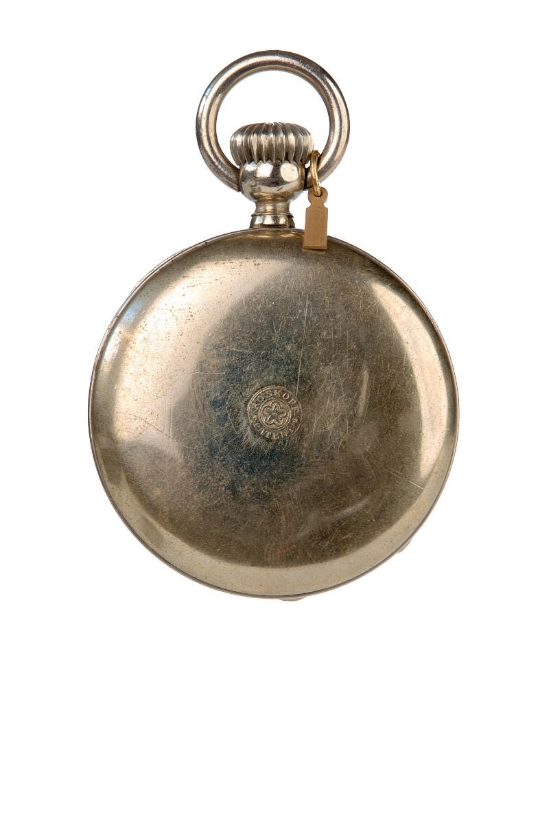 The bezel of the very heavy nickel silver case may be opened to set the hands manually (MIH I-375)