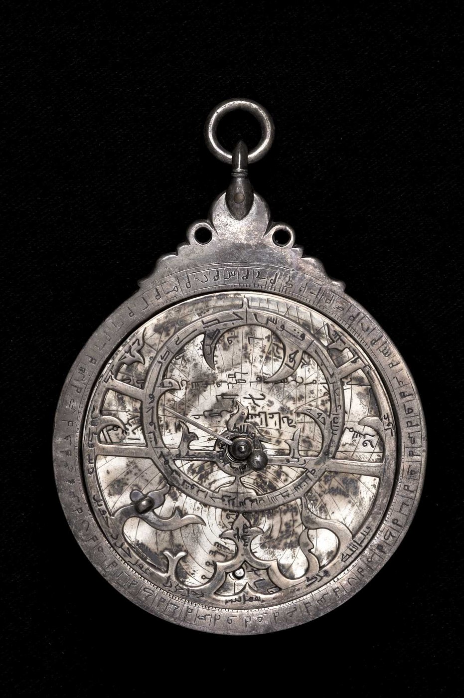 View of the front of the silver astrolabe, showing the pierced Indo-Persian throne, the rete with foliate pointers, and the bird-shaped Vega pointer.