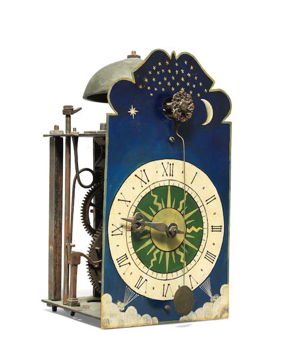 Three-quarter view of the continental iron posted clock with front cow-tail pendulum and painted dial